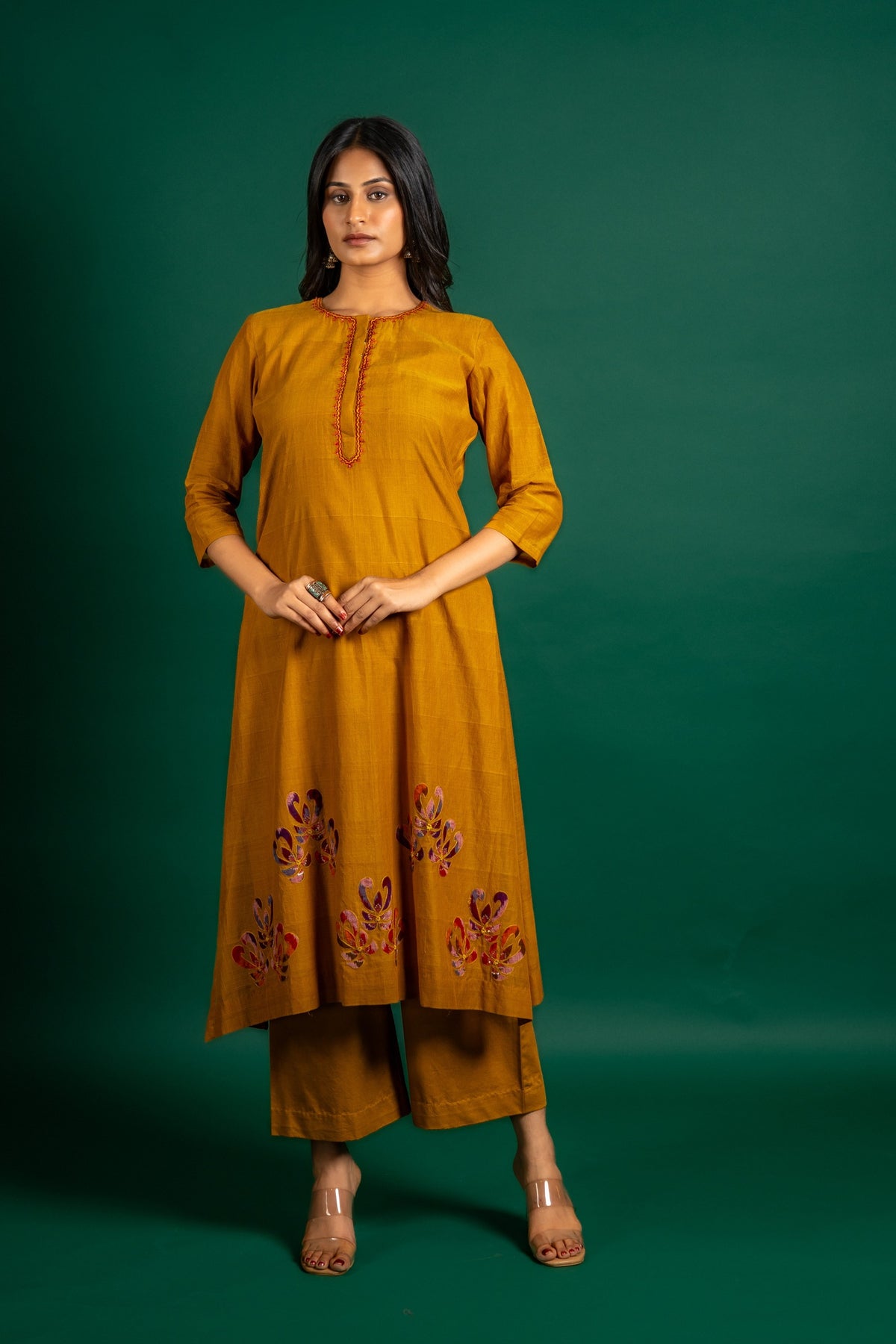 Mustard A-line handloom top with thread work on neck, the Daman is highlighted with appliqué work and sequin detailing, and cotton pant