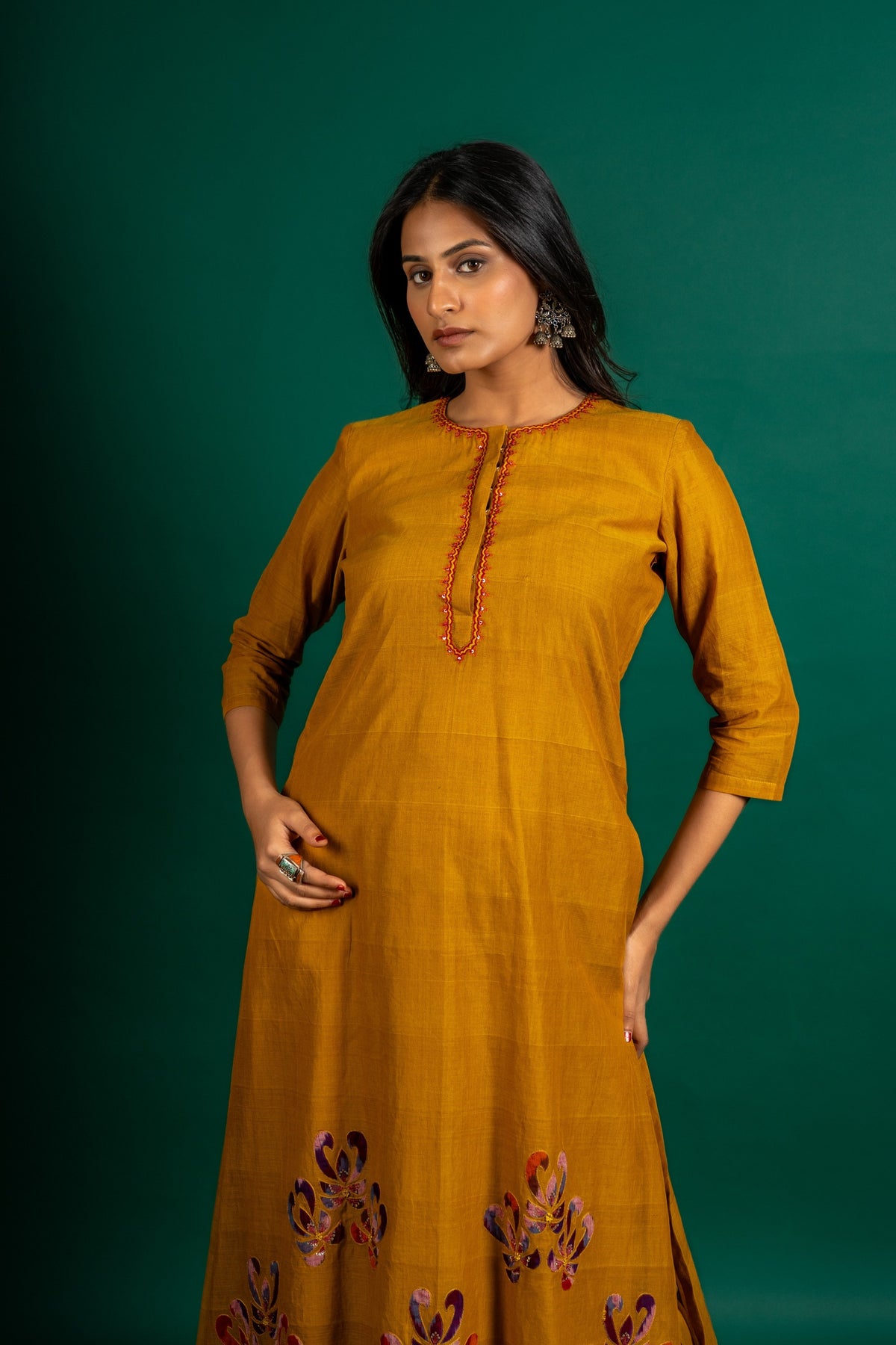 Mustard A-line handloom top with thread work on neck, the Daman is highlighted with appliqué work and sequin detailing, and cotton pant
