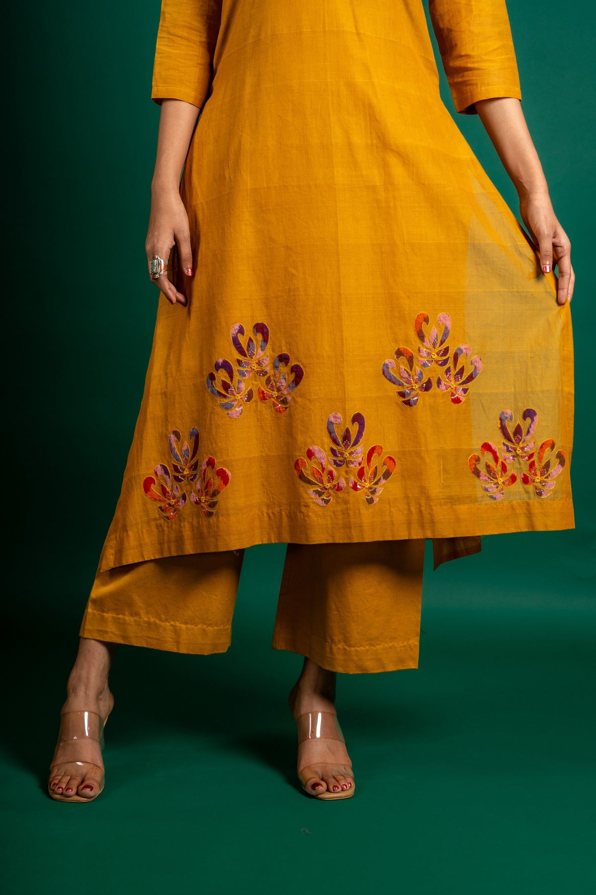 Mustard A-line handloom top with thread work on neck, the Daman is highlighted with appliqué work and sequin detailing, and cotton pant