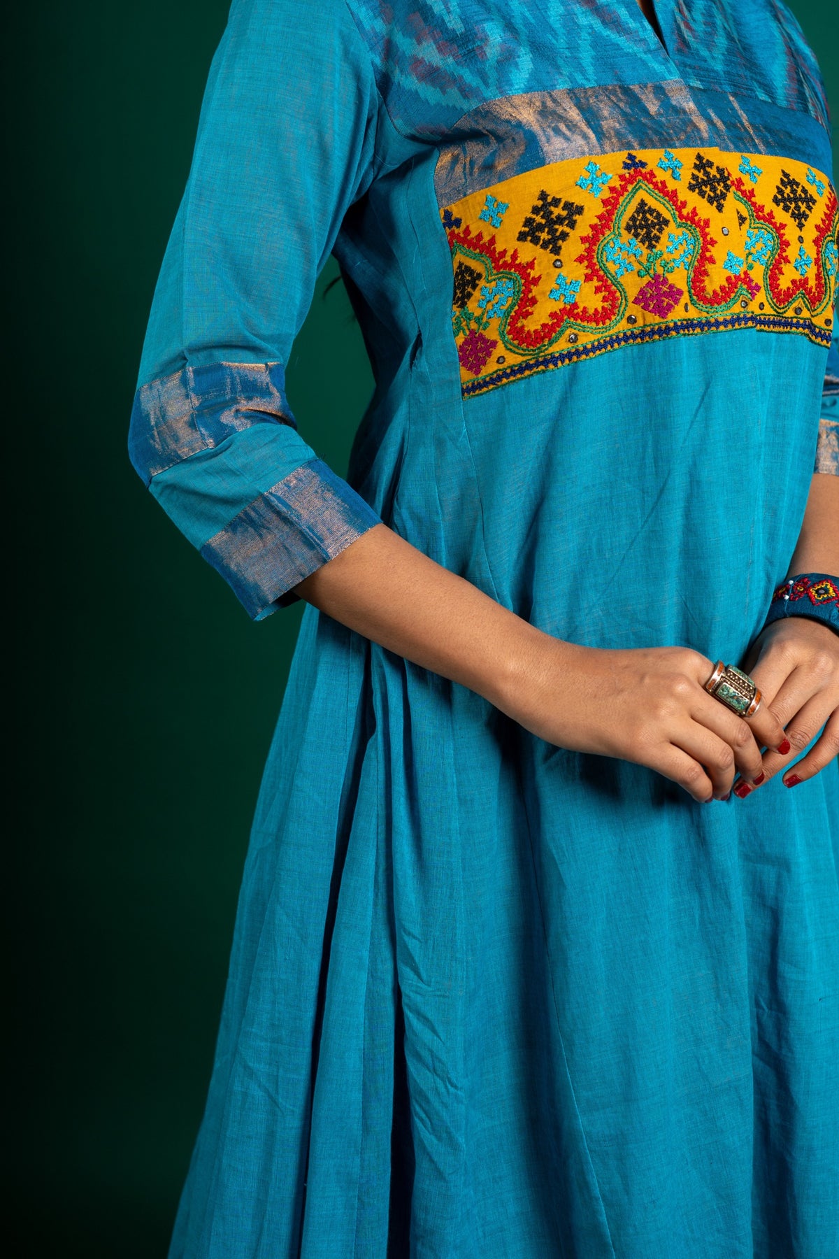 Blue handloom Kali top paired with ikat and Kutch work on yoke with mustard dupatta with work and pant