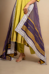 Green handloom Kali top ikat yoke with thread and mirror work and Daman anchor lines, purple Kota dupatta with work, cotton pant