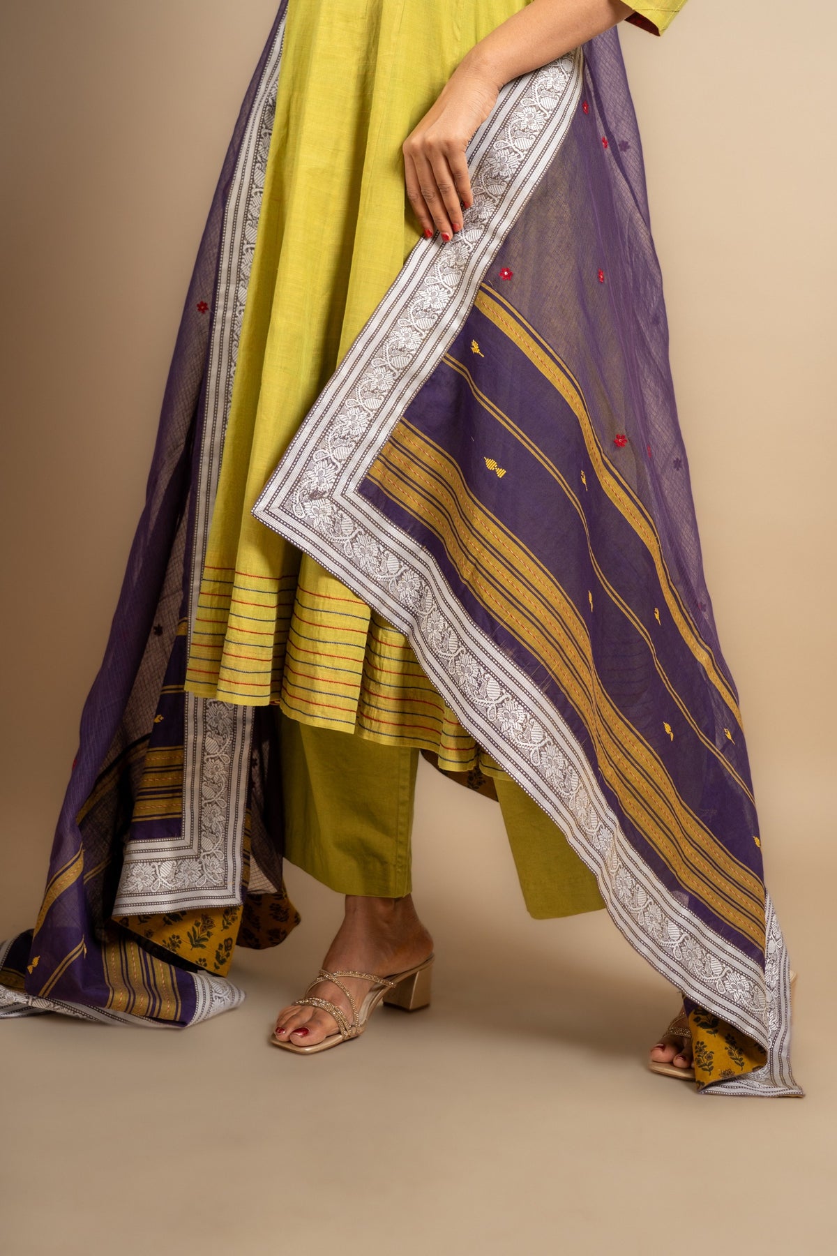 Green handloom Kali top ikat yoke with thread and mirror work and Daman anchor lines, purple Kota dupatta with work, cotton pant