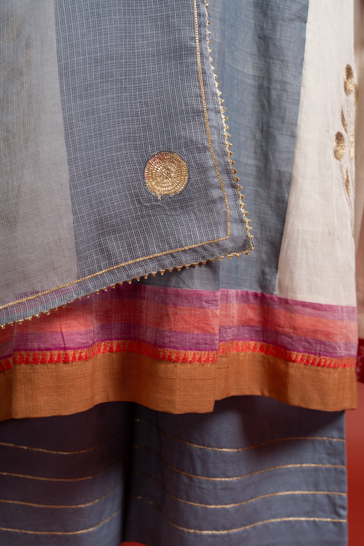 Grey and off white panel handloom top with Gota lace work on yoke in Daman zari pita work and grey Kota dupatta with work and cotton pant