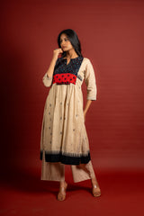 Beige shade with black thread butta in the centre, a temple border on the Daman, and thread with mirror detailing on the yoke, cotton pant