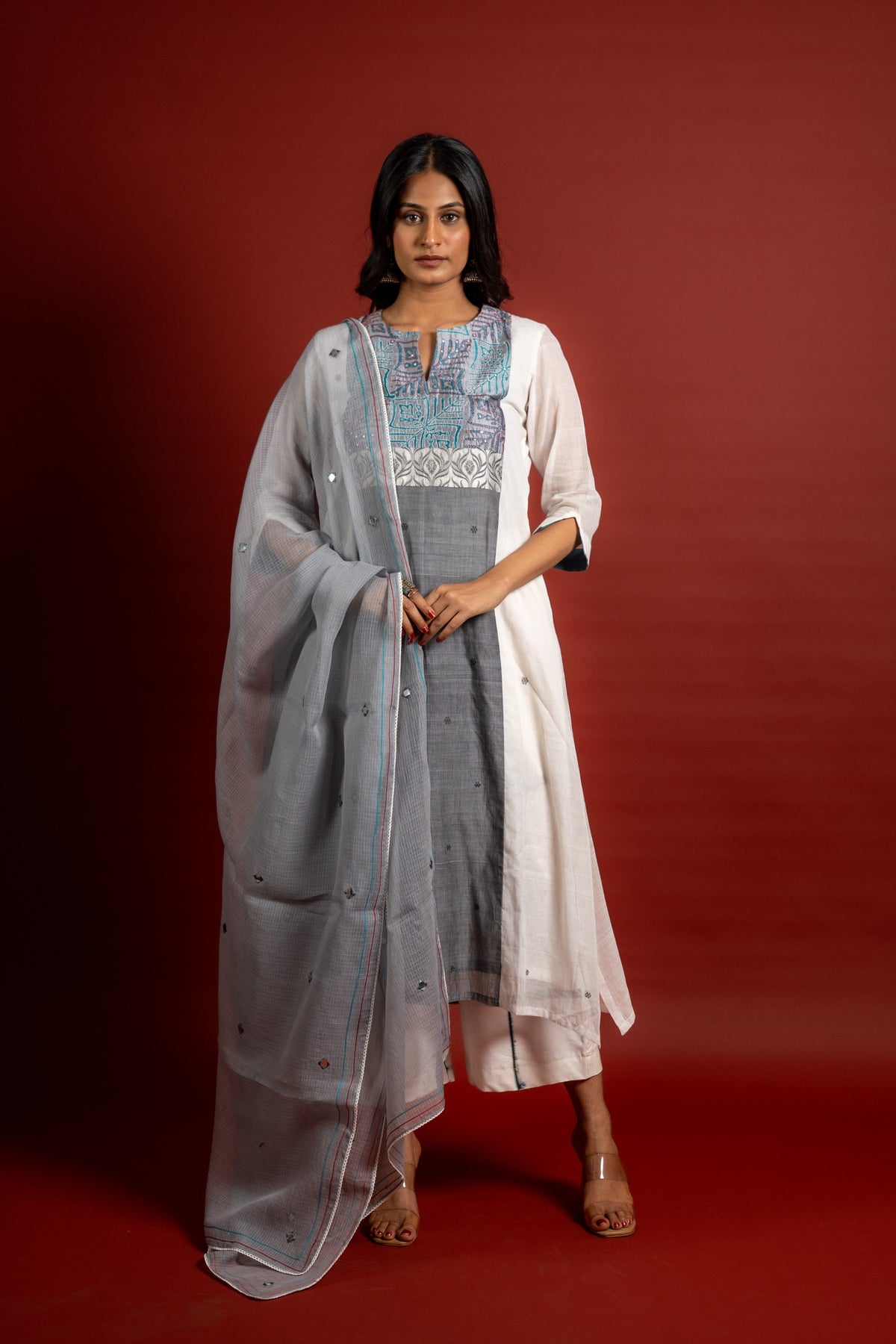 Off white and grey panel handloom top, kanta work on yoke with grey Kota dupatta with mirror work, tie and dye pant