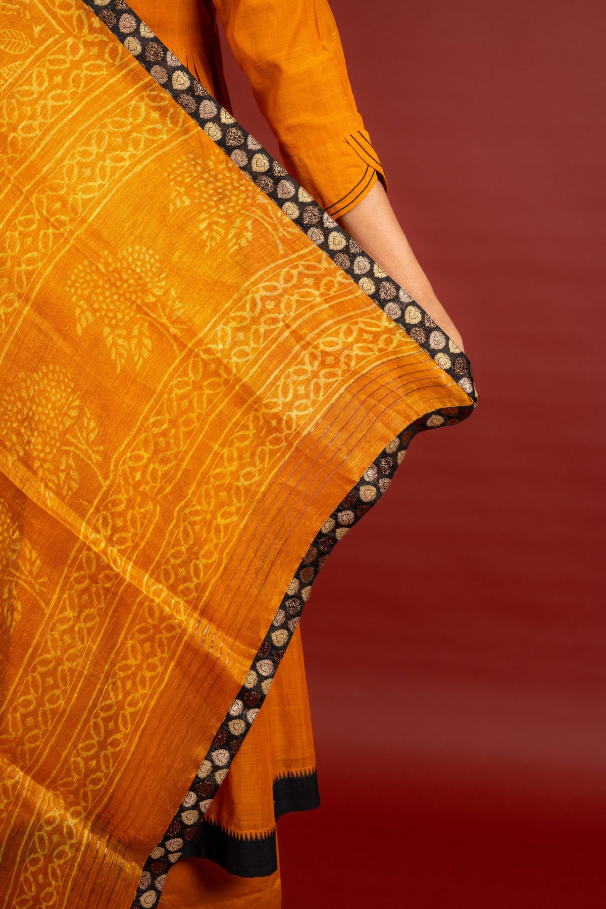 Saffron shade handloom Kali top with kalamkari with tiny mirror work, delicate zari work on neck with Maheshwari dupatta and pant