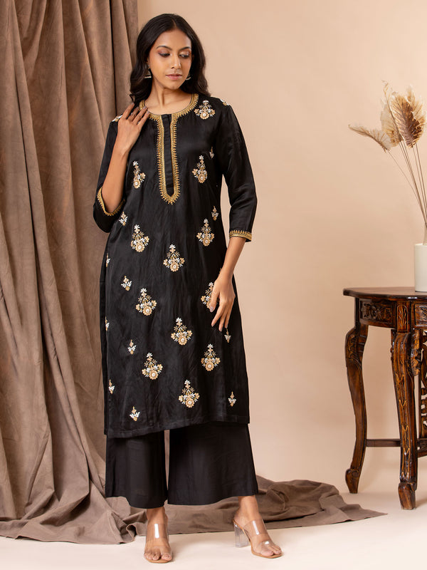 Black linen satin straight-cut top with Gota Patti and threadwork bhutis, paired with rayon pants.