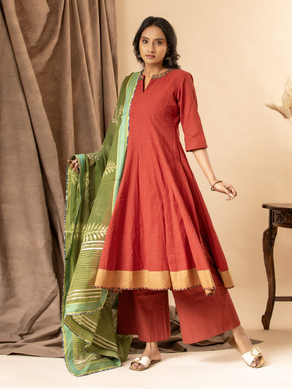 Burnt red handloom checkered kalidar with a green printed Kota dupatta highlighted with sequins, paired with loose pants