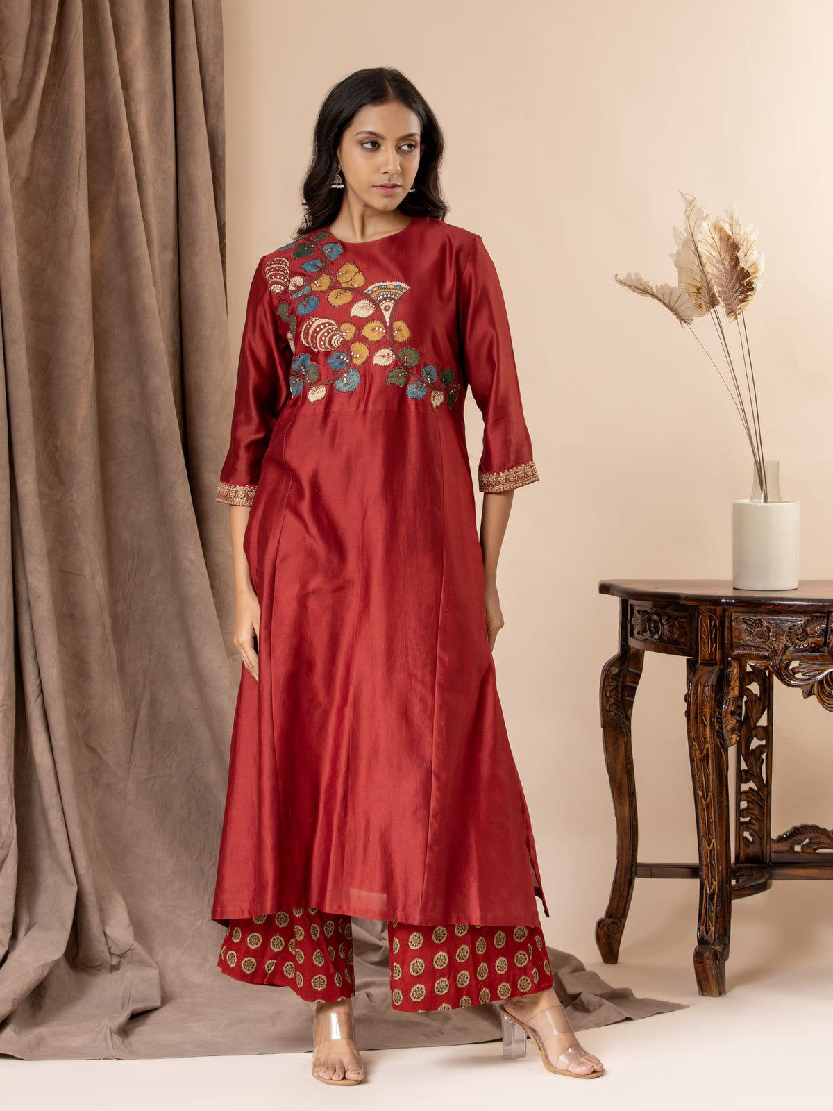 Crimson red Chanderi panel top with hand-painted Kalamkari applique work, paired with printed pants