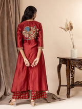Crimson red Chanderi panel top with hand-painted Kalamkari applique work, paired with printed pants