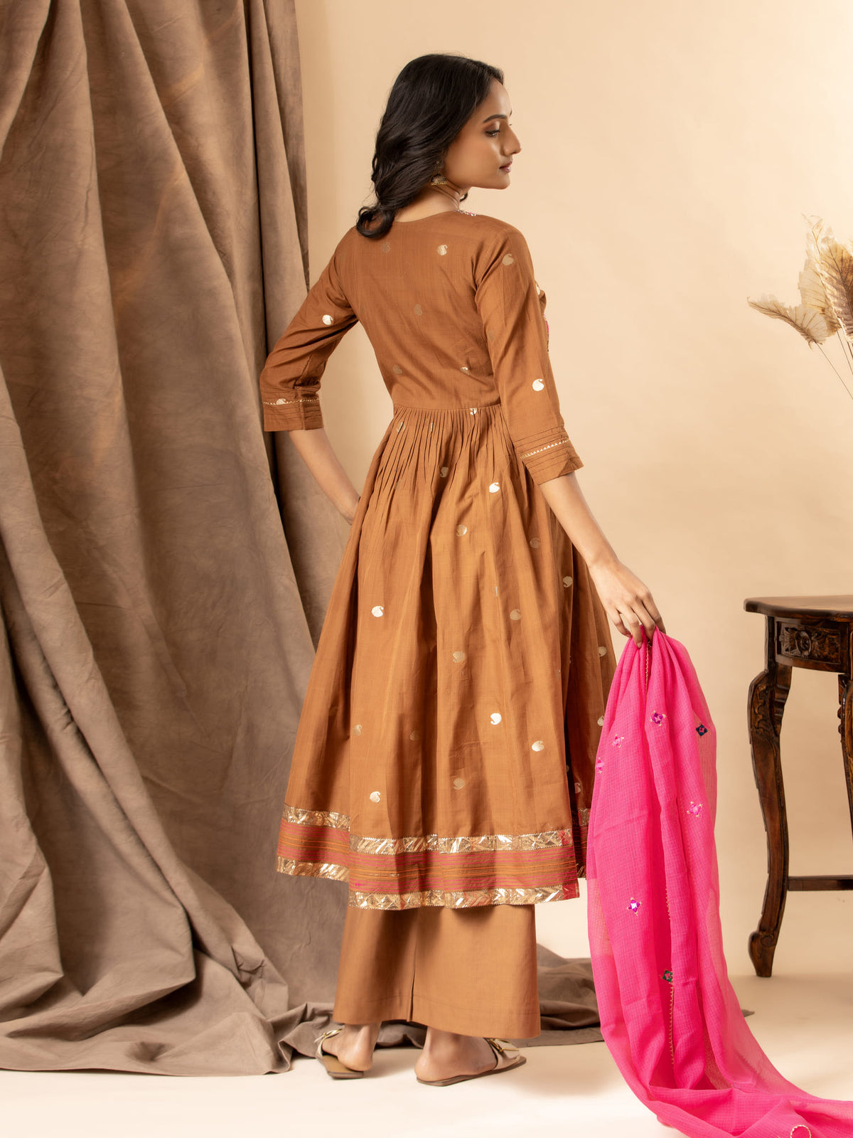 Handwoven brown top with silver zari buti, gathered kali design, and Gujari work with sequin detailing on the yoke