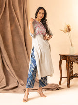 Handwoven light grey A-line panel top with handwork yoke featuring thread and mirror work, paired with blue printed pants