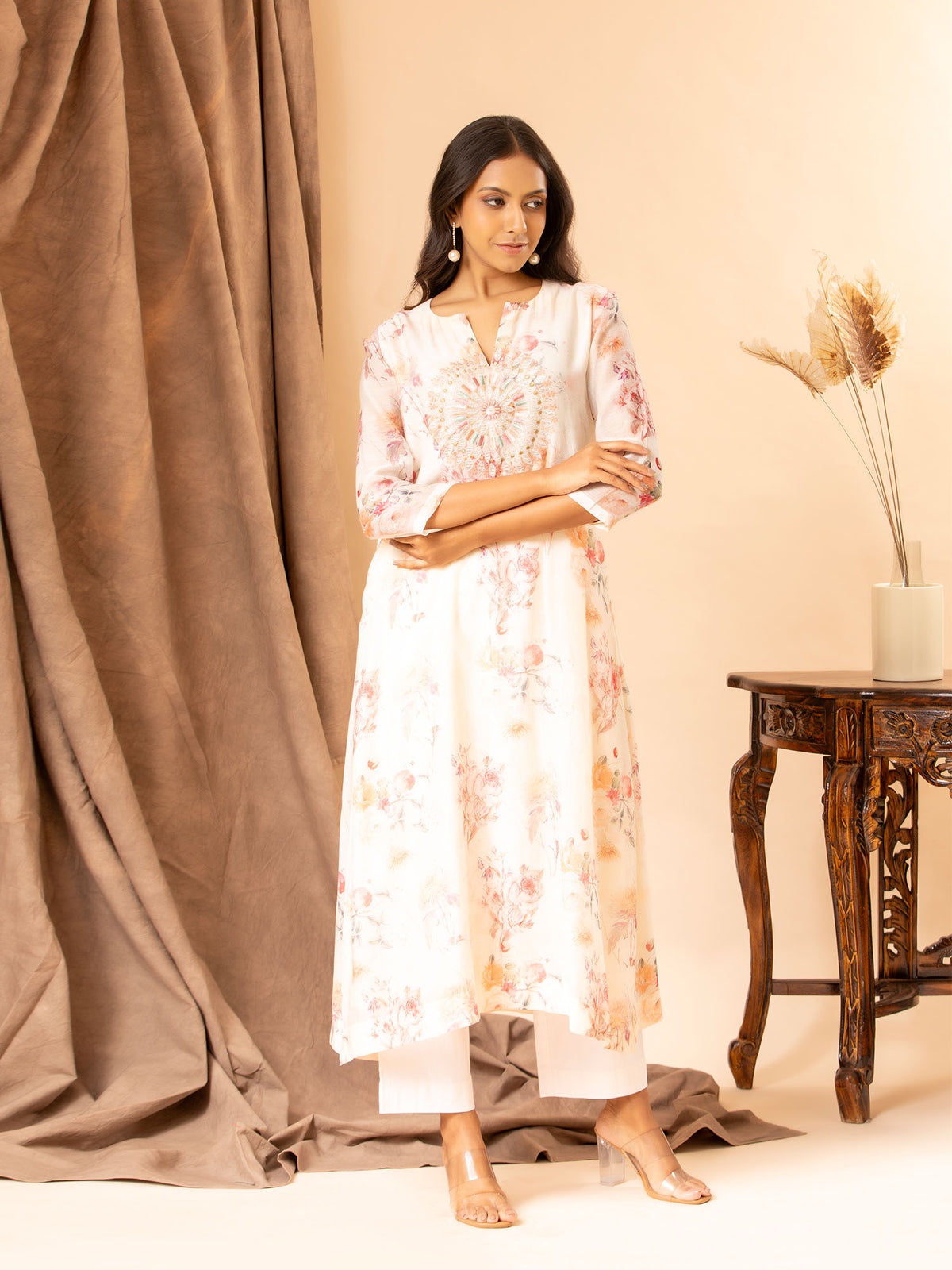 Ivory floral printed Chanderi straight cut top with embroidery on the yoke, paired with stretchable Lycra pants