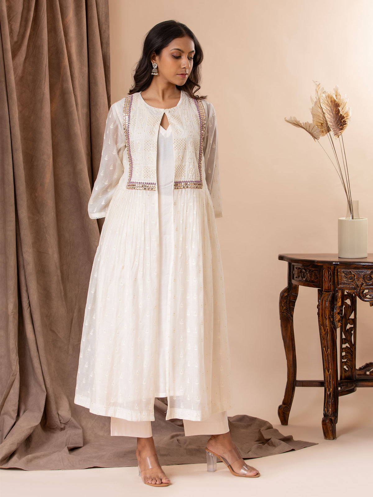 Ivory self-thread bhuti coatstyle top with a hand embroidery detailing, paired with a slip and pants