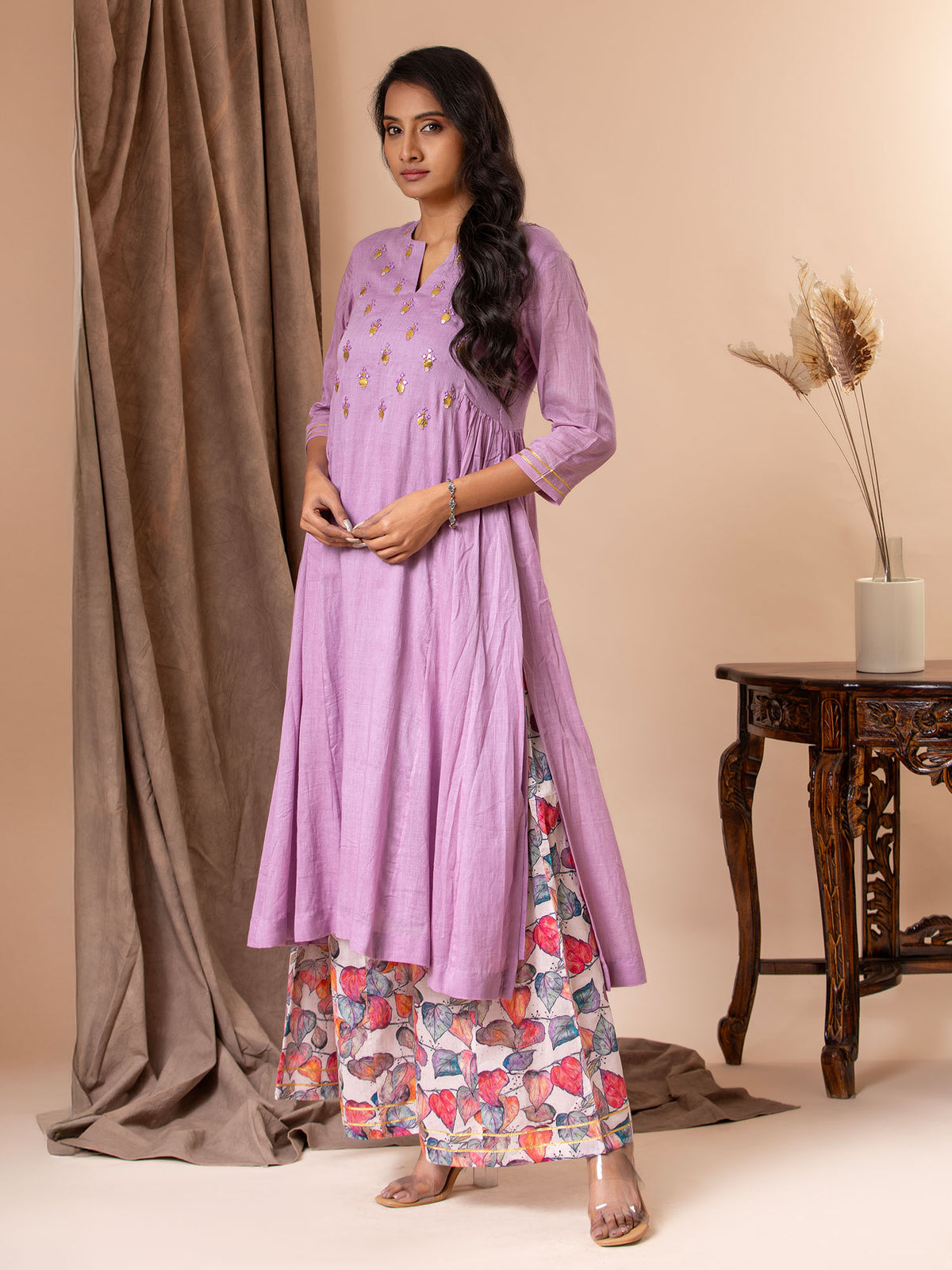 Lavender mul fabric panel top with side gathers, Gota and mirror detailing on the yoke, paired with printed colorful pants.