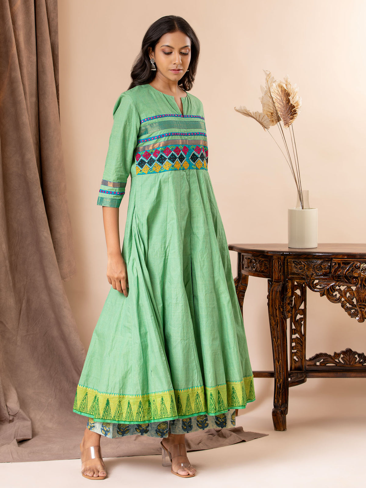 Light green kali top with Kutch work and mirror work, paired with batik printed pants