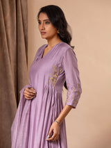 Light purple muslin top with gathered details on the sides and hand embroidery work, paired with a Chanderi embroidered dupatta along with pants.