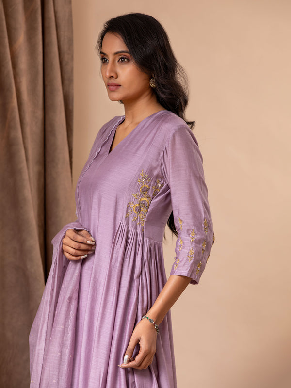 Light purple muslin top with gathered details on the sides and hand embroidery work, paired with a Chanderi embroidered dupatta along with pants.