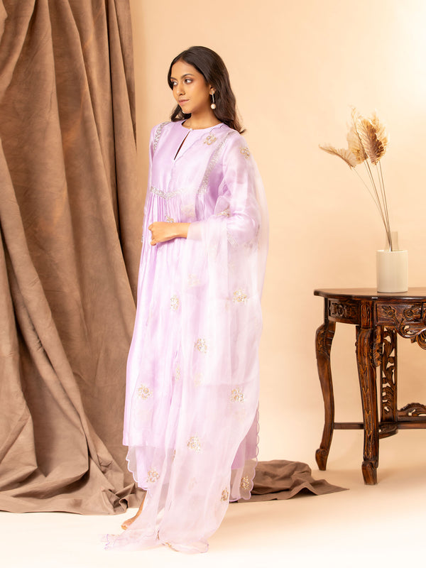 Lilac Chanderi top with panel and gathers, featuring sequin hand embroidery work detailing, paired with an organza dupatta highlighted with handwork bhuttis and matching pants