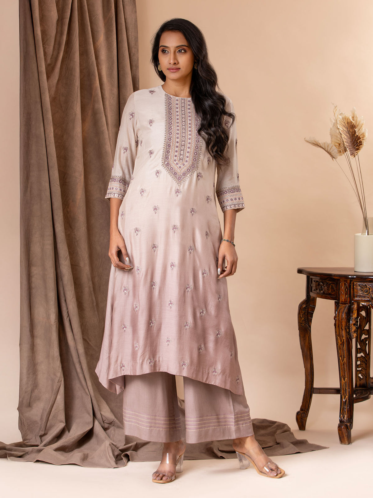 Muslin top in shades of mauve with all over thread and mirror handwork, paired with pants.