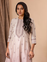 Muslin top in shades of mauve with all over thread and mirror handwork, paired with pants.