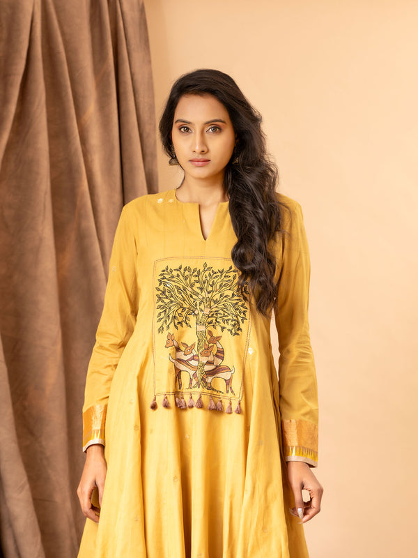 Mustard yellow handwoven dress with zall over zari bhuti and thread embroidery on the yoke.