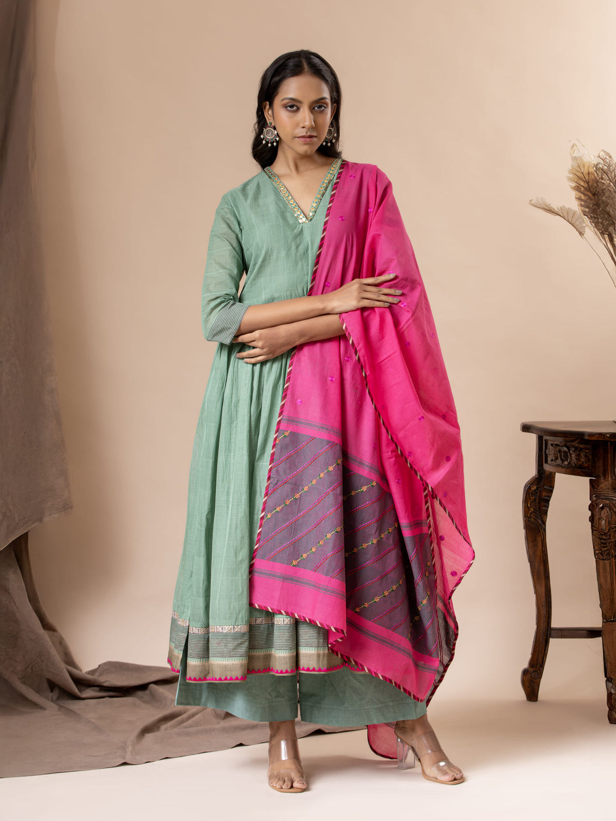 Muted teal handwoven top paired with a pink handwoven dupatta featuring thread work detailing, and matching pants