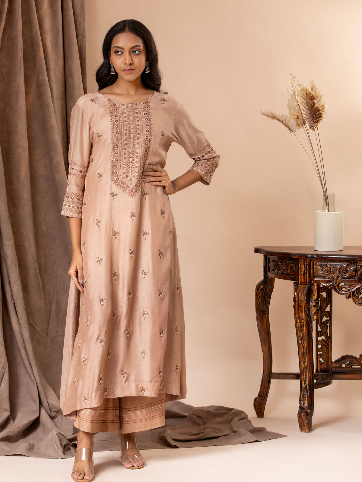 Pale brown muslin top with all over thread and mirror handwork, paired with pants.