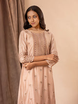 Pale brown muslin top with all over thread and mirror handwork, paired with pants.