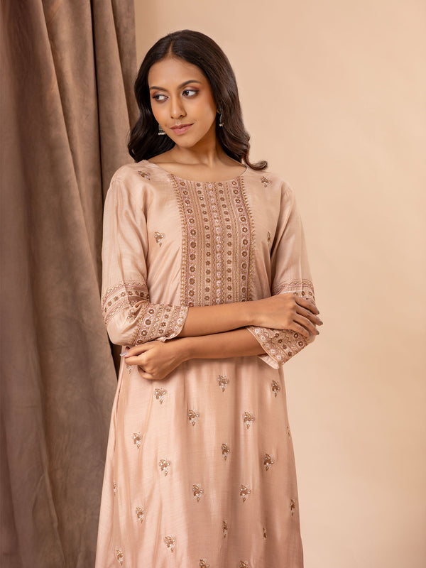 Pale brown muslin top with all over thread and mirror handwork, paired with pants.