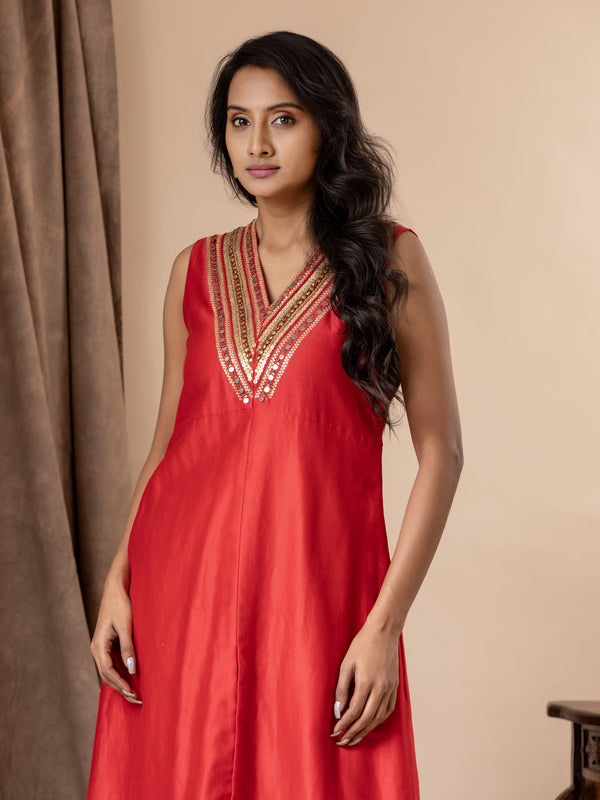 Scarlet red Chanderi straightcut top with sequin and coin work detailing on the neckline, paired with Bandhani pants