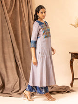 Soft grey handwoven kali top with Kutch work and mirror yoke, featuring Kalamkari patchwork on the back, paired with printed Chanderi pants