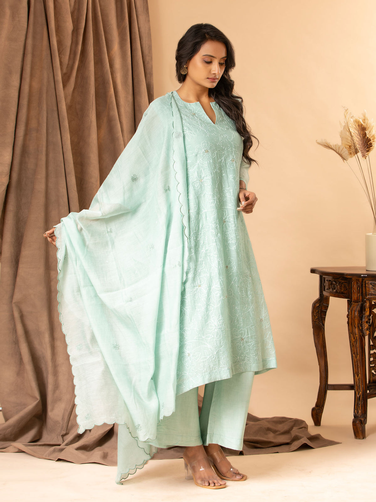 Soft mint green cotton Chanderi top with all-over thread work, highlighted with sequins, paired with a dupatta featuring thread butti