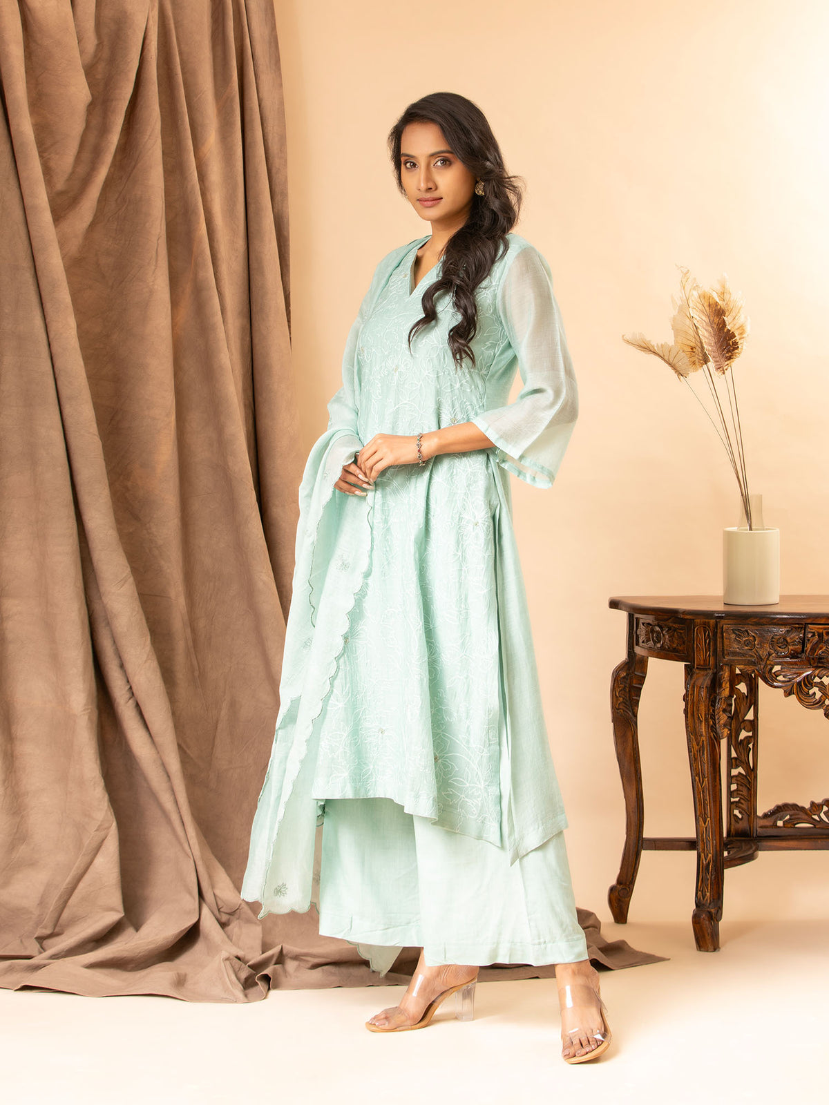 Soft mint green cotton Chanderi top with all-over thread work, highlighted with sequins, paired with a dupatta featuring thread butti