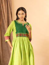 Vibrant green handwoven gathered top with tiny mirror and Kutch work on the yoke, paired with matching pants