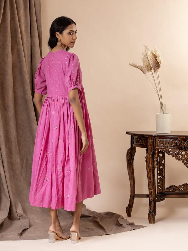 Vibrant pink mul cotton frock with tiny mirrors on the yoke, pleated detailing, puffed sleeves, and thread bhuttis