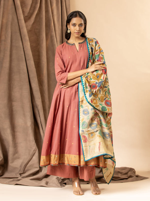 Warm terracotta handwoven top with mirror work on the neckline, paired with a Kalamkari dupatta and matching pants