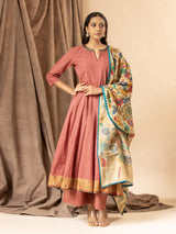 Warm terracotta handwoven top with mirror work on the neckline, paired with a Kalamkari dupatta and matching pants