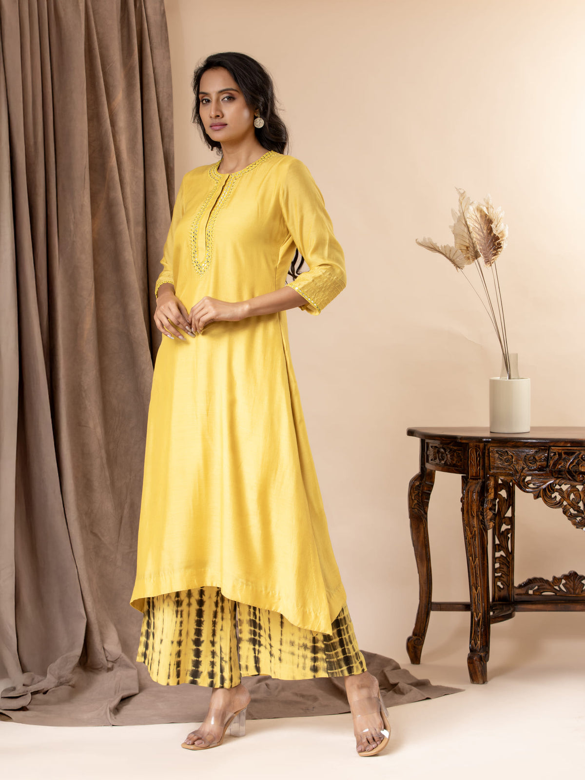 Yellow muslin top with thread and mirror work detailing, paired with Shibori tie-and-dye pants