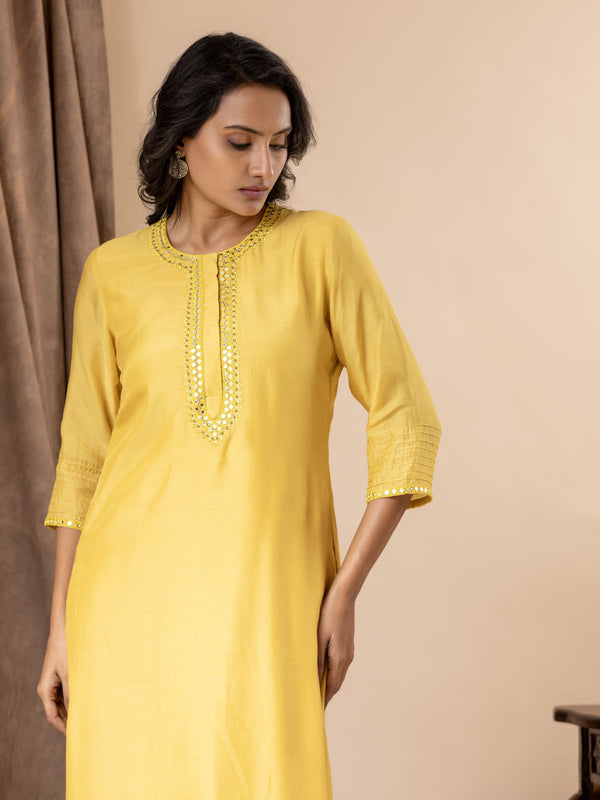Yellow muslin top with thread and mirror work detailing, paired with Shibori tie-and-dye pants