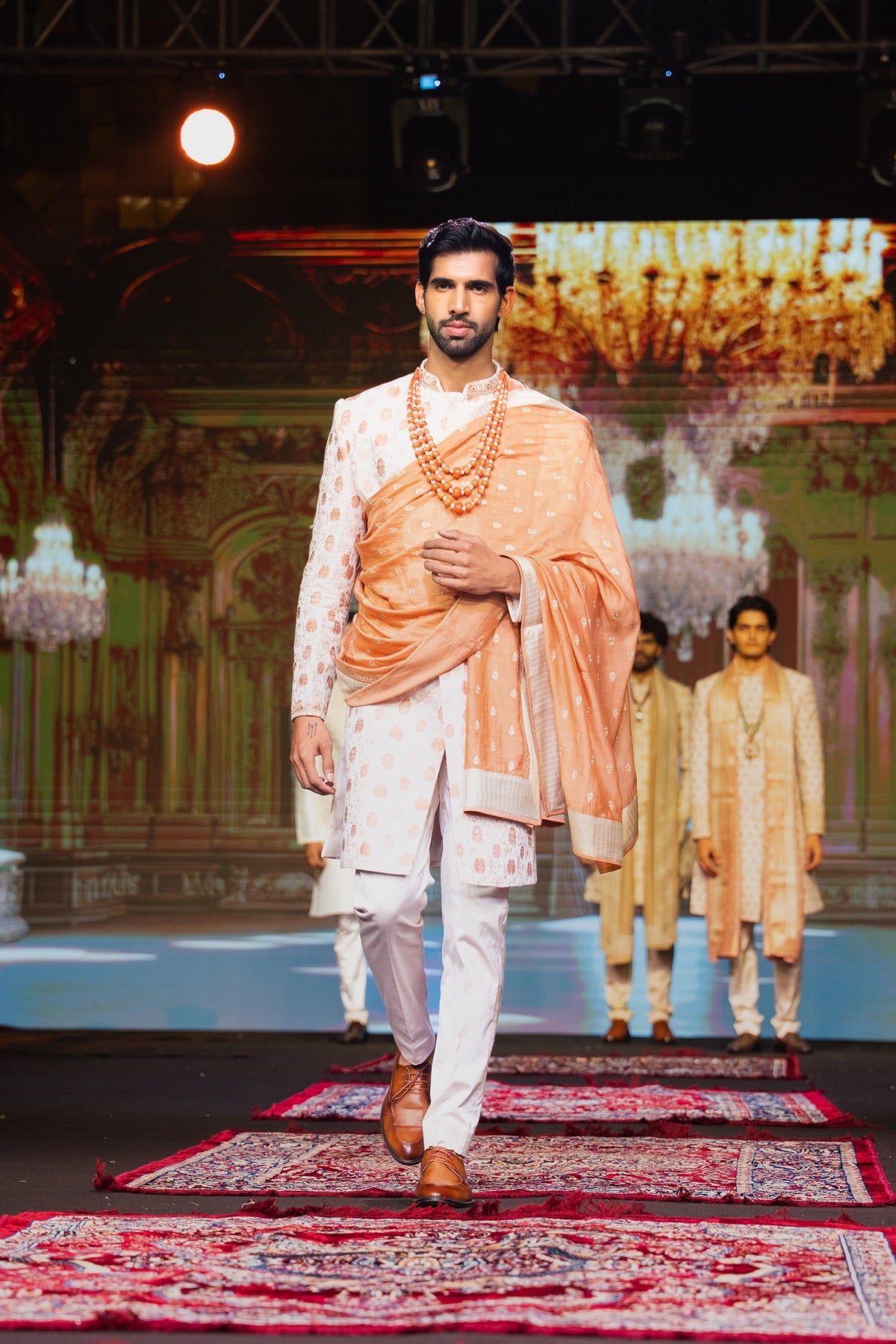 Menswear look in cream and copper on the runway
