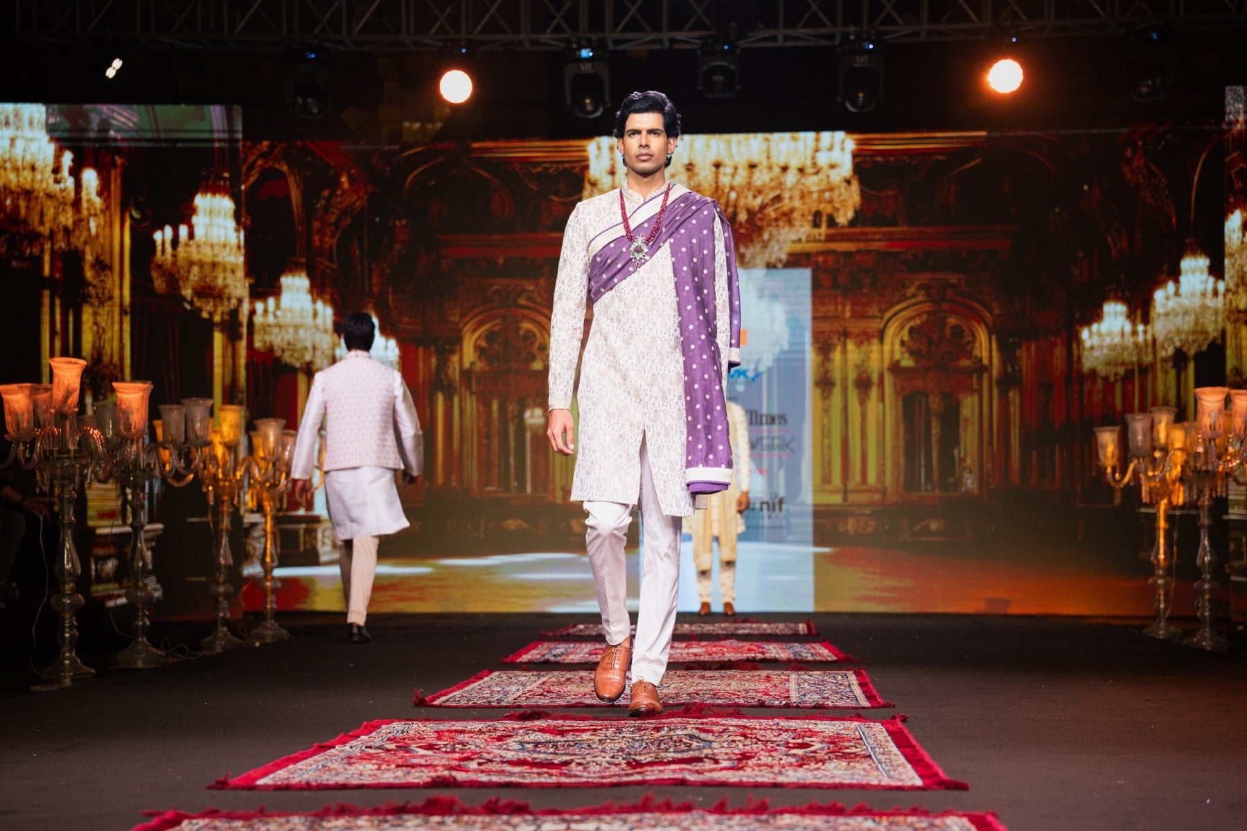 Menswear look in purple and white on the runway