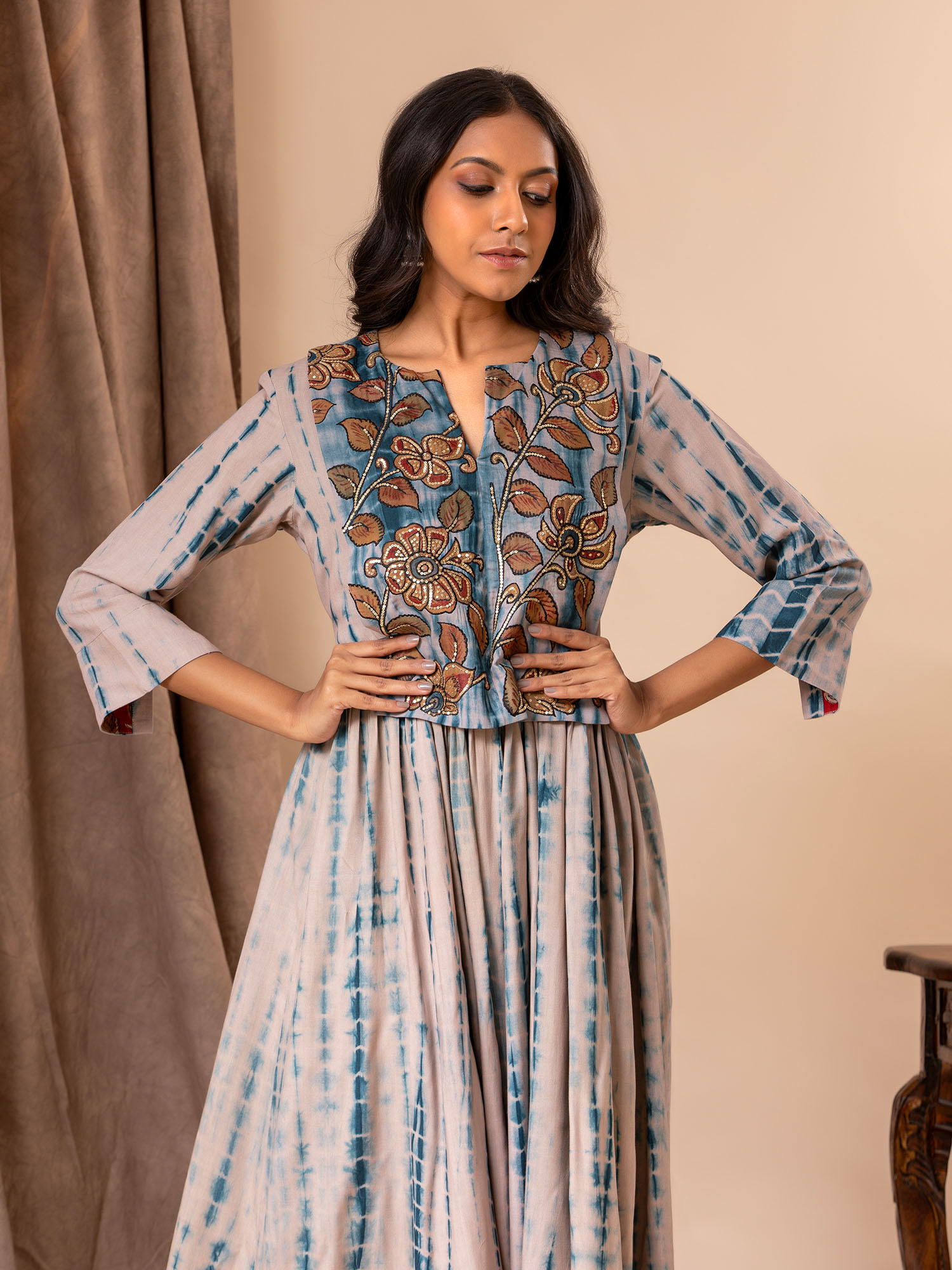 Grey and blue tie-and-dye (Shibori) muslin frock with a Kalamkari yoke highlighted with sequin work.
